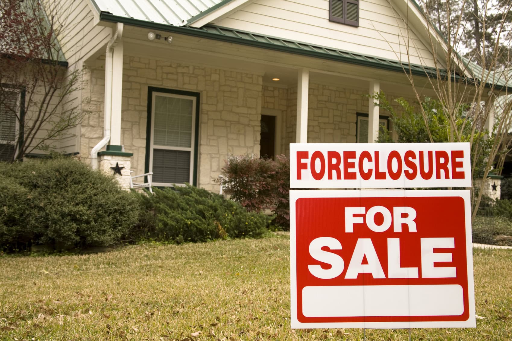 Foreclosure sale sign on a house indicating property is for sale due to eviction.