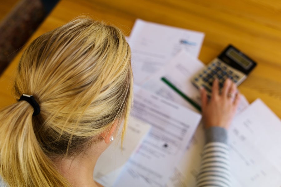 Dealing with debt, bankruptcy, and foreclosure paperwork on a wooden desk.