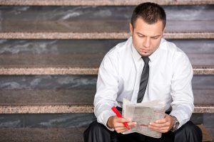 Financial advisor reviewing legal documents for bankruptcy or foreclosure matters.