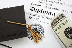 Scholarship cap and rolled dollar bill on a diploma document, symbolizing financial aid and education funding.