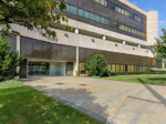 Empty office building on Long Island with modern architecture and green landscaping.
