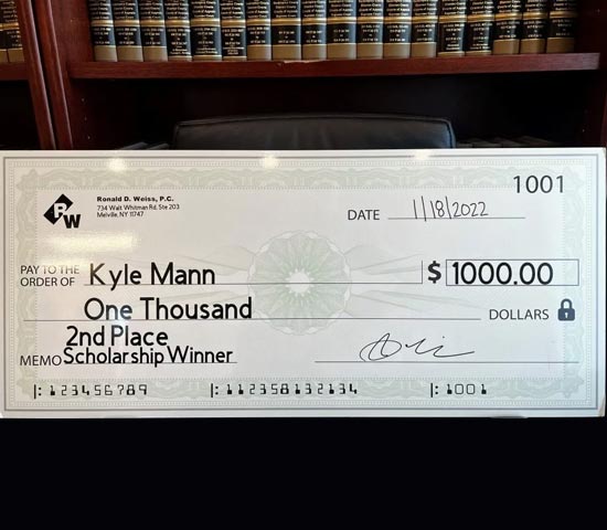 A check made out to Kyle Mann for $1,000, dated November 18, 2022, placed in front of a bookshelf filled with books; the check number is 1001 and the issuer appears to be 'RW' based on the logo