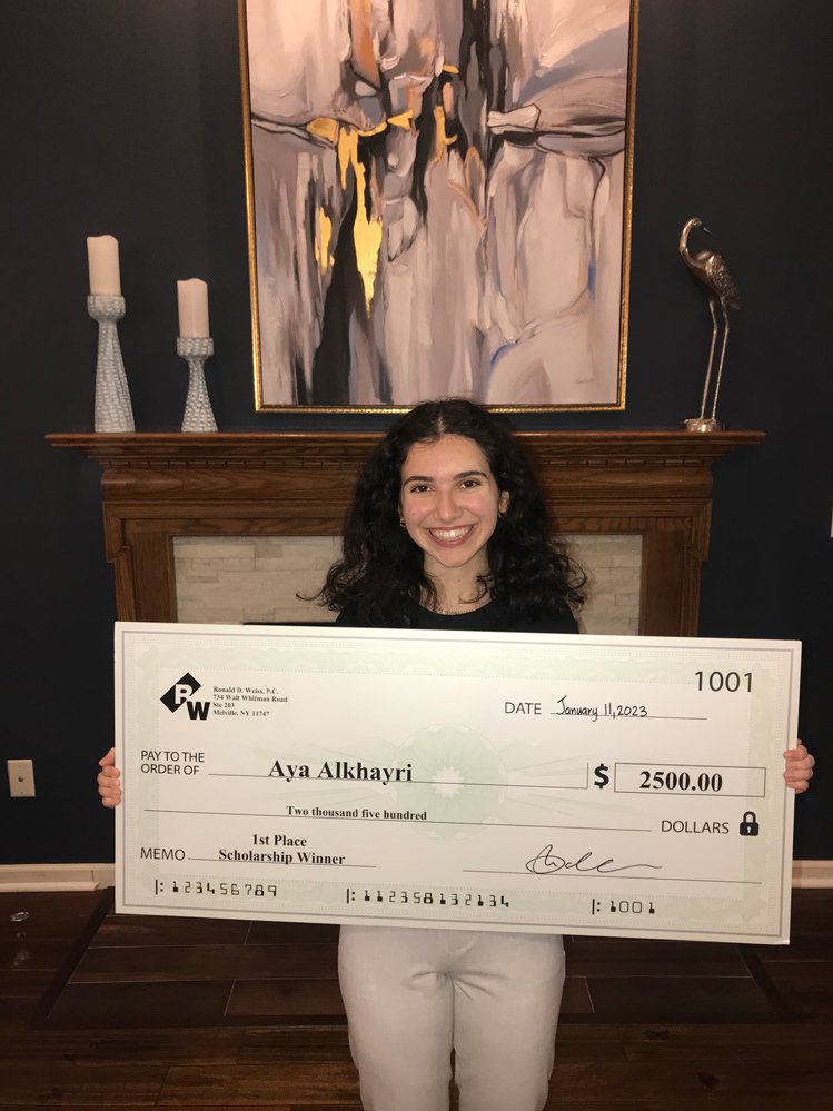 Bankruptcy award announcement, girl holding a large check for scholarship prize.